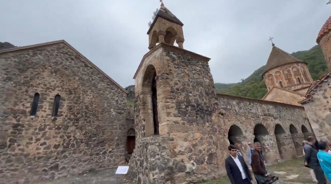 A year after displacing Armenians, Azerbaijani state officials visit the Dadivank Monastery in Artsakh